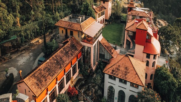 An aerial view of a villa with multiple buildings, a swimming pool, and lush greenery. - Mango Hill Yercaud (Yercaud)