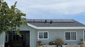 A modern house with a garage, a covered patio, and solar panels on the roof. - Remodeled Studio w/Fast Wi-Fi in Heart of Bay Area (Milpitas)
