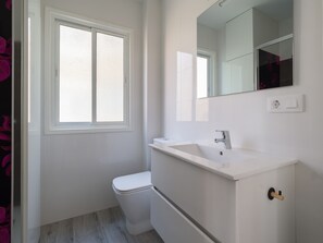 Regadera, secadora de cabello, toallas, papel de baño 