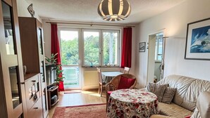A cozy living room with a sofa, a small round table, and a red rug. - Karsten by Interhome (Zinnowitz)