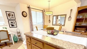 A kitchen with wooden cabinets, a granite countertop, and a window with blinds. - Spacious 5 Bedroom Home, two blocks to FSU. Oversized parking for up to 8 cars (Tallahassee)