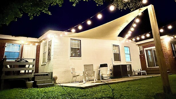 A house with a covered patio, outdoor seating, and string lights. - Spacious 5 Bedroom Home, two blocks to FSU. Oversized parking for up to 8 cars (Tallahassee)