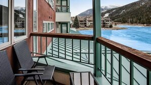 A balcony with a view of a mountain and a lake. - Lakeside Village 1 Bedroom Condo in Lakeshore Complex (Keystone)