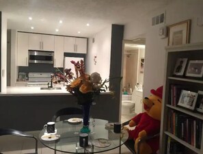 Enjoy meals in this well-equipped kitchen with a dining table and modern appliances.