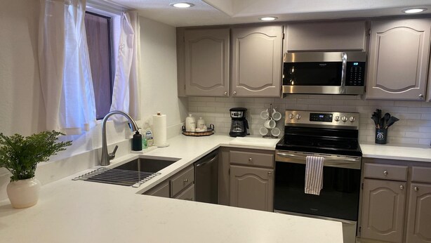 A modern kitchen with stainless steel appliances, a built-in oven, and a coffee maker. - CASA AVENTURA - Anasazi Village - Views (Phoenix)