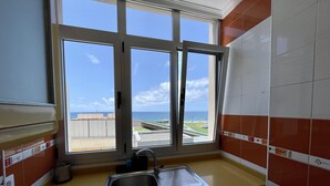 A kitchen with a large window, a stainless steel sink, and a dishwasher. - Las Canteras View Home (Las Palmas de Gran Canaria)