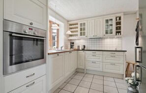 Fridge, stovetop, dishwasher, coffee/tea maker