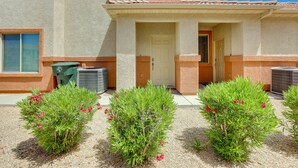 A building with a beige exterior, a door, and two air conditioning units. - Mesquite Vacation Rental Condo w/ Resort Amenities (Mesquite)