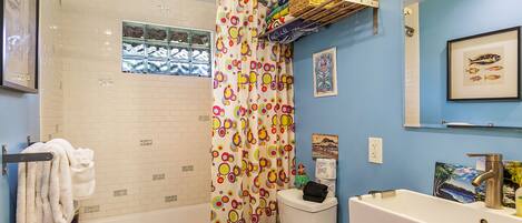 A bathroom with a bathtub, toilet, and sink.