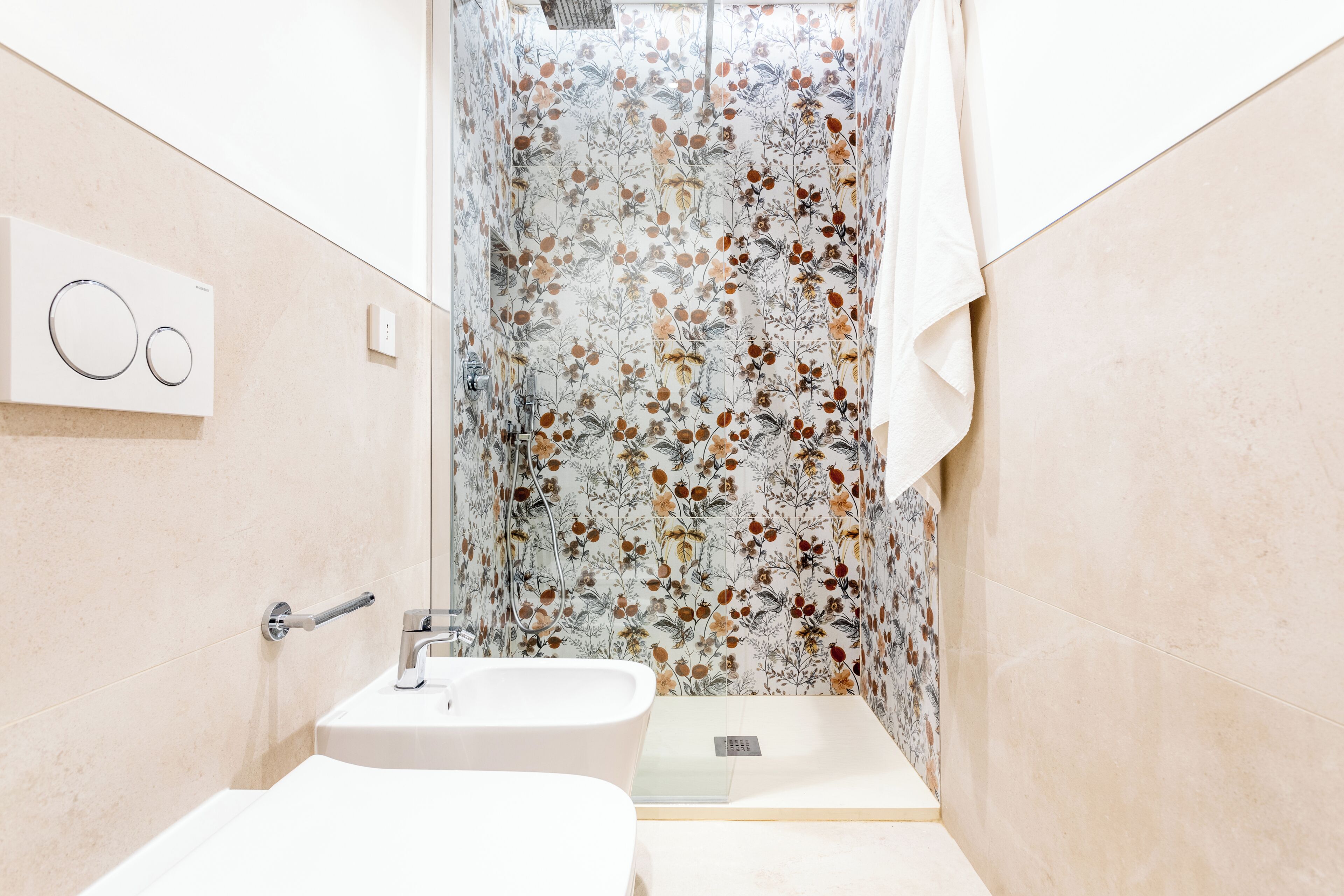 A bathroom with a shower, a sink, and a toilet.
