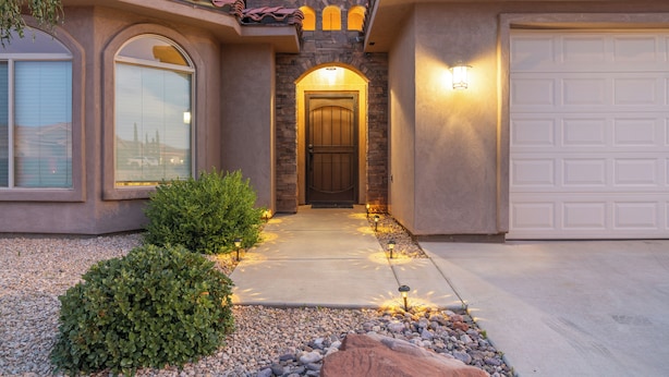 A house with a stone facade, a wooden front door, and a garage. - Red Rock Hangout: Big Hot Tub, Firepit, BBQ, Game Room, Communal Spaces (Page)