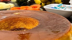 A close-up of a caramel flan with a glossy caramel topping. - Hotel Lara 10 Curitiba (Curitiba)