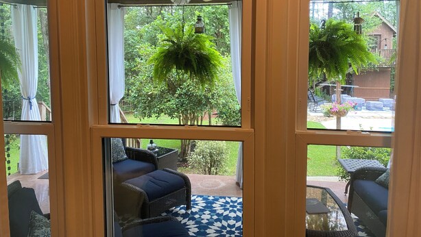 A room with a view of a patio area featuring outdoor furniture and a patterned rug. - French Tudor in Quiet Aiken County (Aiken)