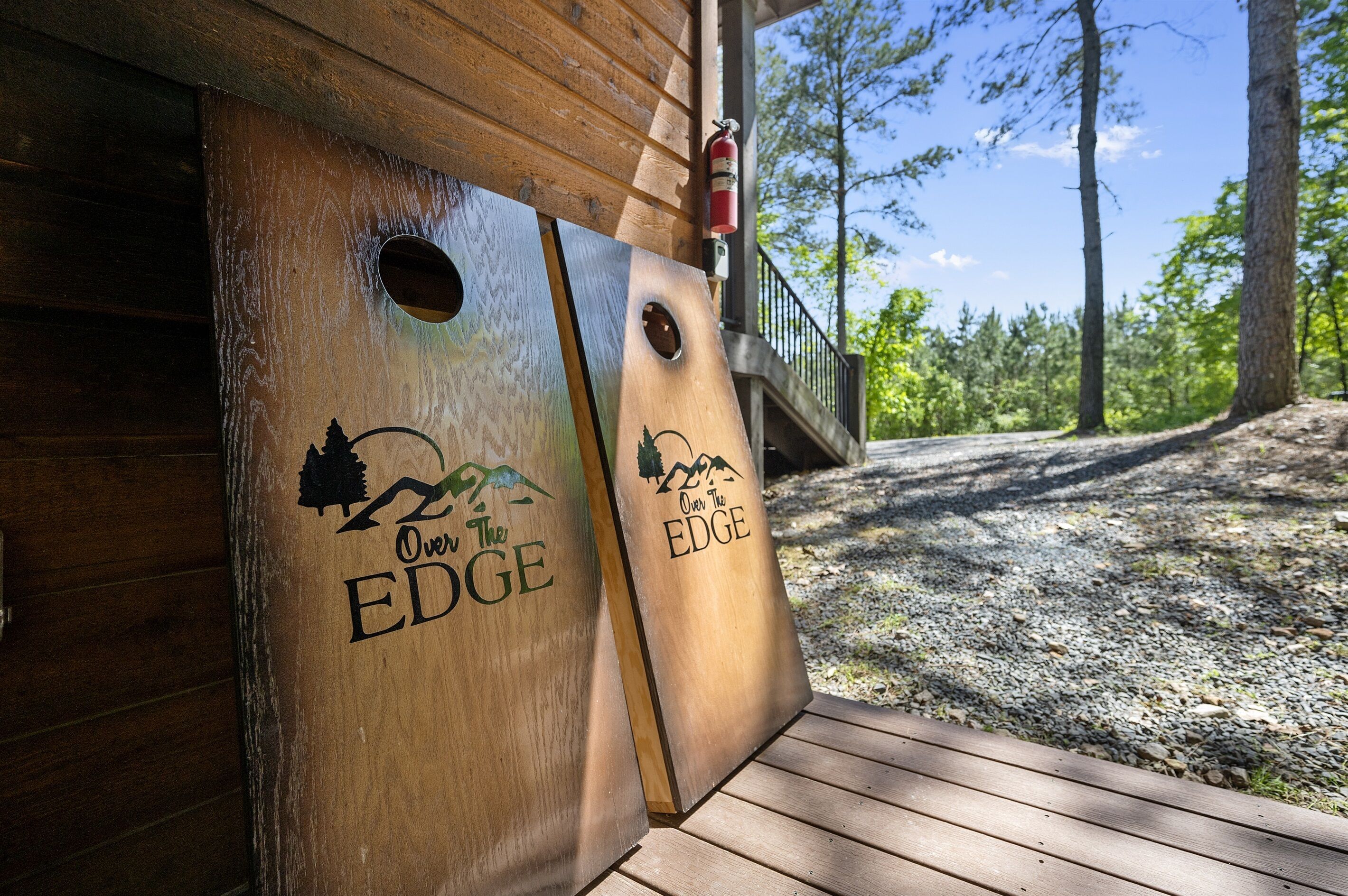 A wooden deck with two wooden planters labeled "Over the EDGE" and "Over the EDGE."