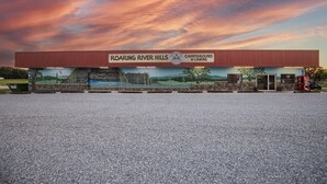 A building with a sign reading "Roaring River Hills Campground & Cabins."