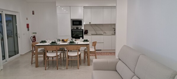 Enjoy a compact living space with a dining area and kitchenette, perfect for self-catering.