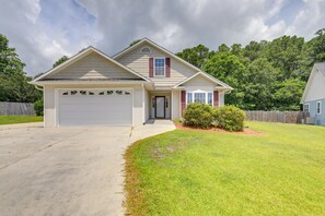 A single-story house with a garage, a front porch, and a well-maintained lawn.