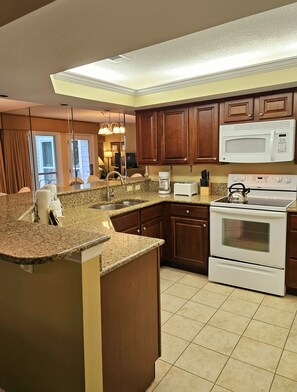 Enjoy cooking in this well-equipped kitchen with a central island, sink, and coffee maker.