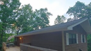 A wooden cabin with a deck, a covered patio, and a gravel area. - Cabin, country setting, yet only minutes from everything! (Statesville)