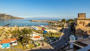 A coastal town with a marina, a beach, and a historic building. - Rosal 3-Giardini Naxos holiday home (Giardini Naxos)