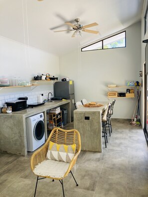 Enjoy cooking and dining in this well-equipped kitchen with a central island, dining area, and ample counter space.
