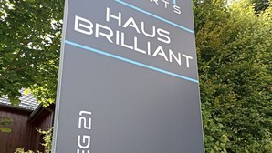 A sign for Smart Resorts Haus Brilliant, indicating the name of the hotel.