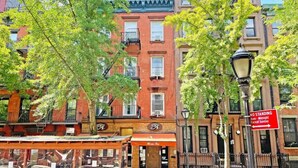 A street view with a red brick building, a 'No Standing' sign, and a bicycle parked in front. - Walk to Time Square! Cozy Studio (New York)