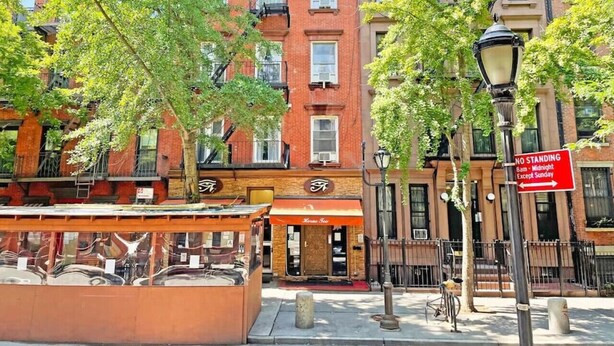 A street view with a red brick building, a 'No Standing' sign, and a street lamp. - Studio Near Restaurants, Broadway, & Shopping (New York)