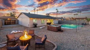 A backyard with a hot tub, a fire pit, and a pool. - Cozy 3BR Stadium Oasis! Pool + Hot Tub + Fire Pit (Glendale)