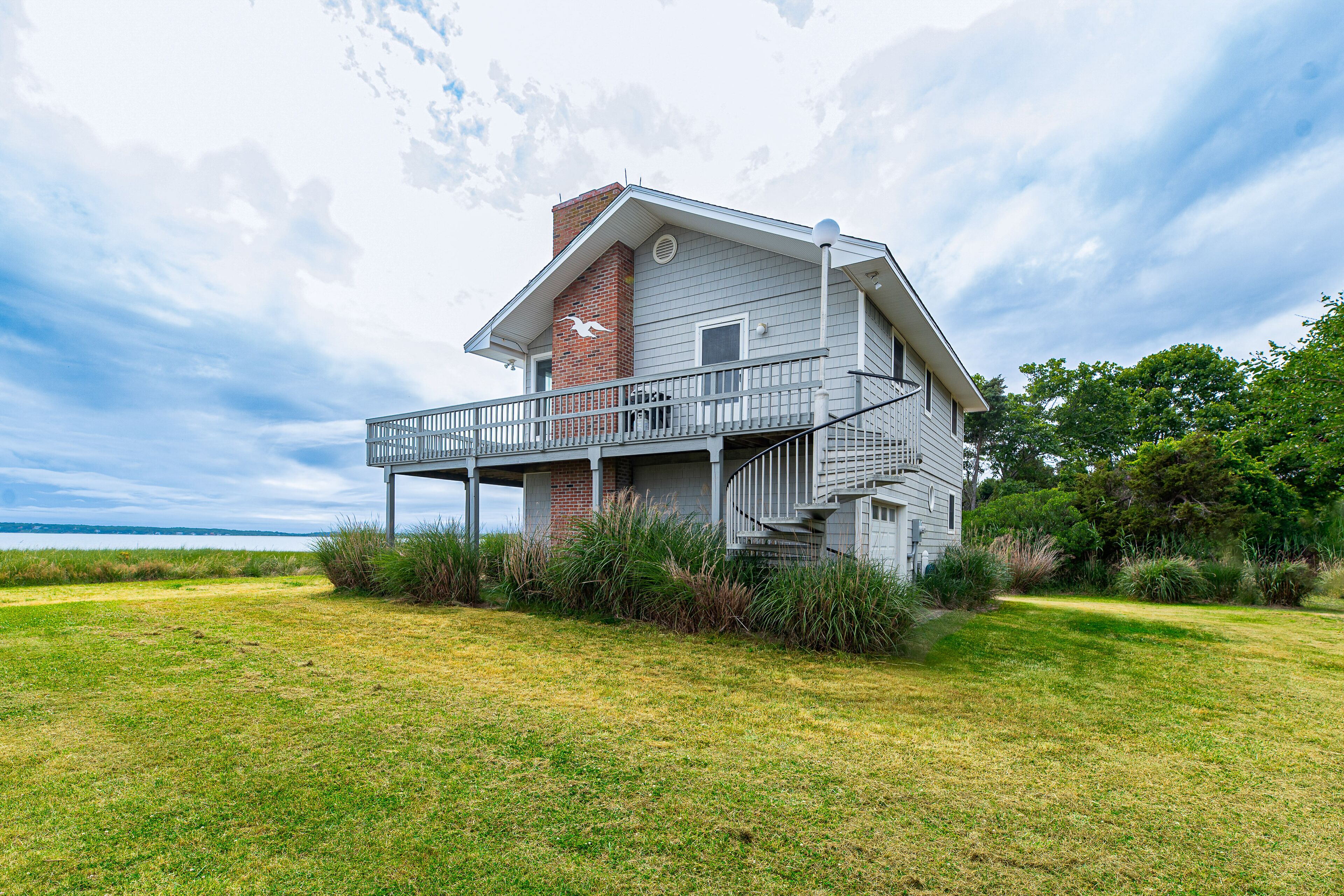 Serene bay front home with a private beach, deck, board games, & washer/dryer