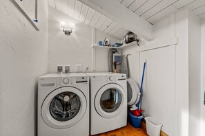 A laundry area with two front-loading washing machines, a ceiling fan, and a mop. - Ski In/Walk Out, Hot Tub, Epic Views, W/D, & Games (Steamboat Springs)