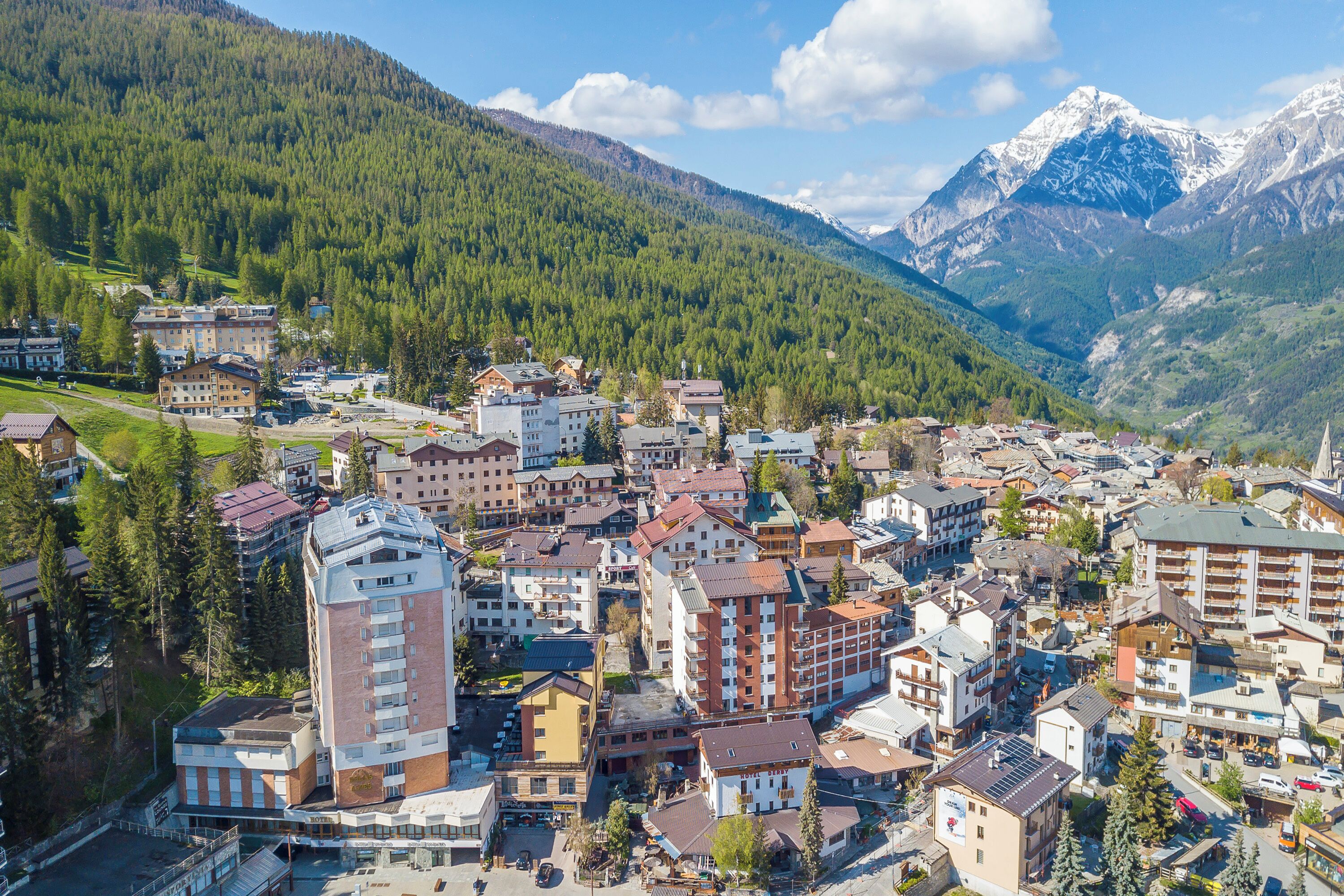A town with buildings, a mountain, and a church.