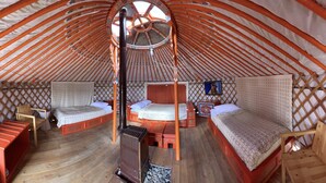 A traditional yurt with two beds, a central wooden structure, and a wooden floor. - Ulaanbaatar (Erdene)