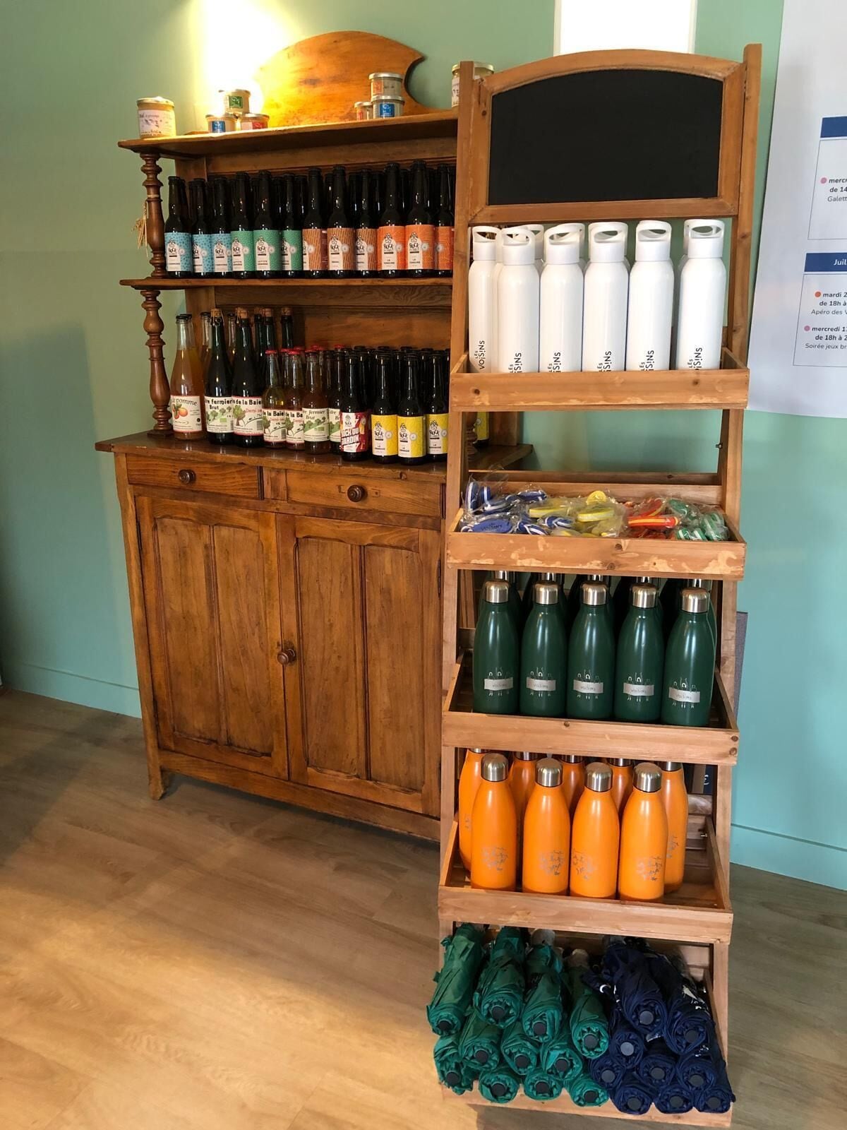 A wooden display shelf with various bottles and containers, likely for sale or display.