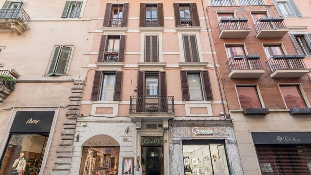A multi-story building with various storefronts, including a visible shop named 'Bollati'.