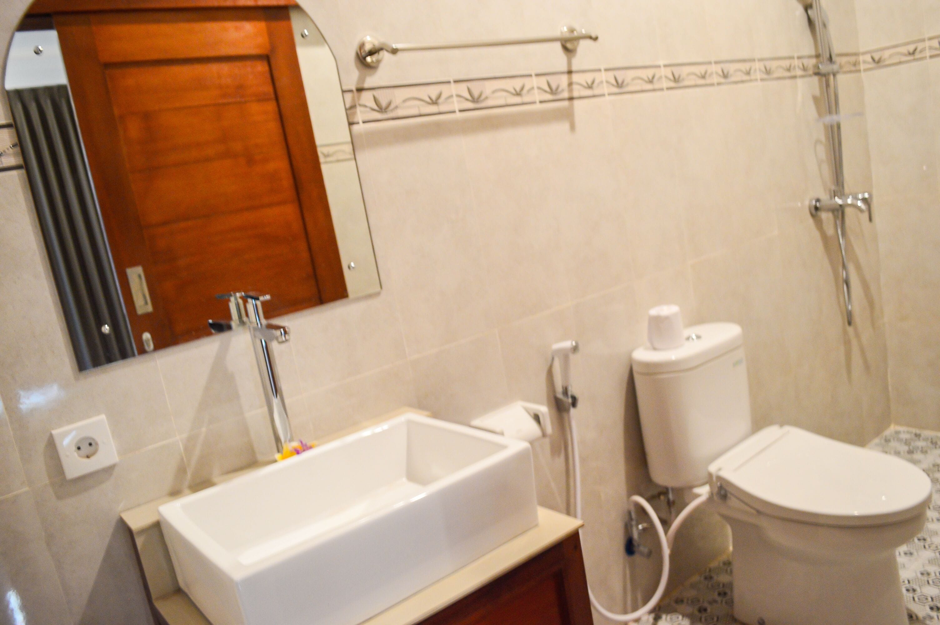 A bathroom with a bathtub, toilet, and shower.