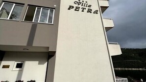 A building with the name 'Villa Petra' on its facade.