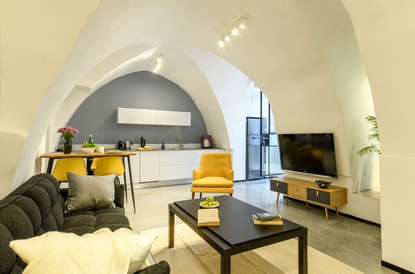 Apartment | Living area | 55-inch flat-screen TV with cable channels, TV - Stylish and Unique 2BR Apt w Patio (Tel Aviv)