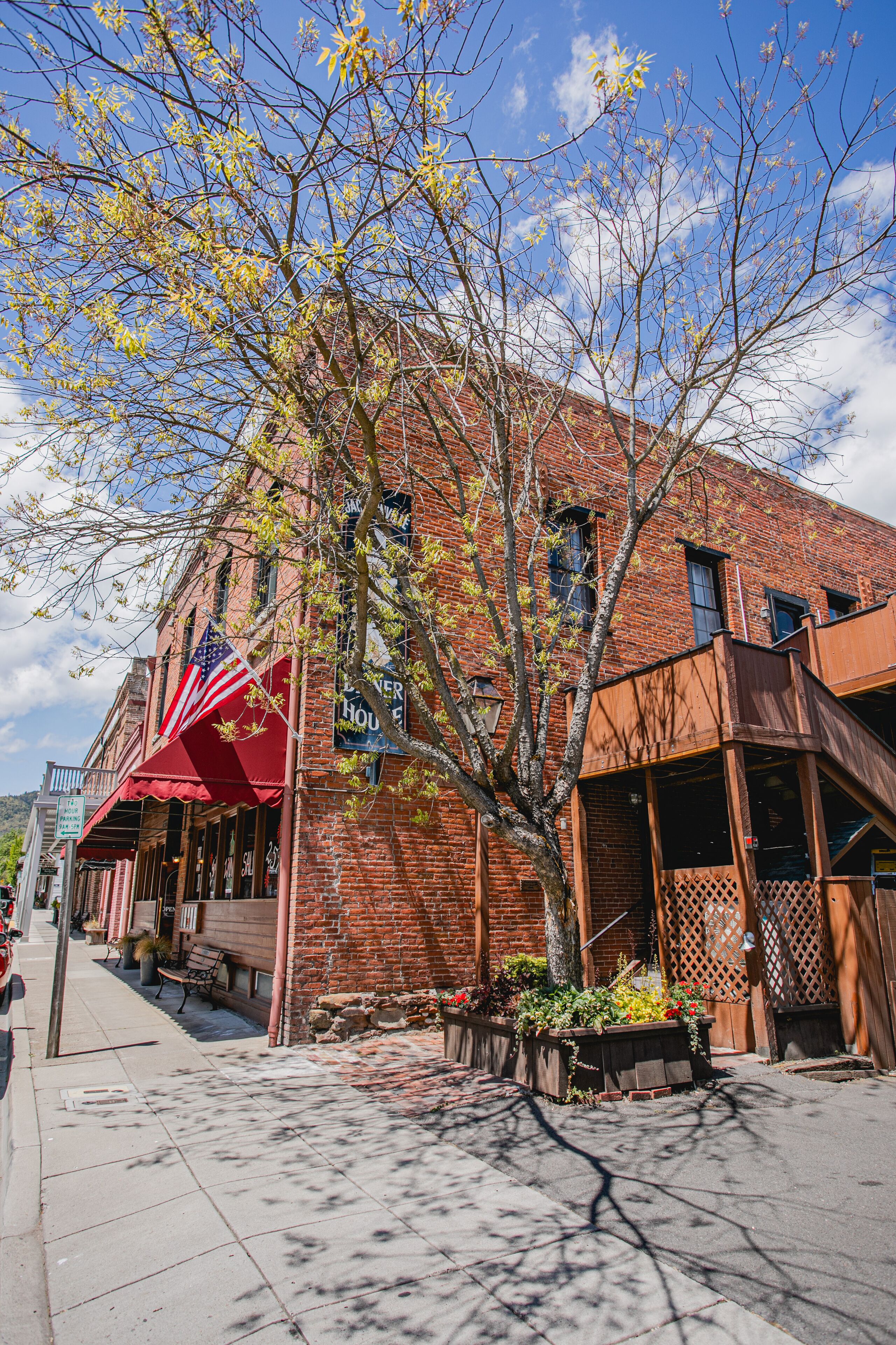 A brick building with a red awning and a sign that reads "Hotel."