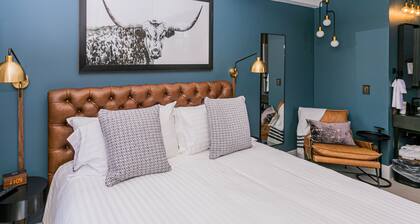 Jacksonville Inn Room #8: King Suite. Prime downtown location for festivals and dining. Comfortable king bed, Nespresso coffee, and historic boutique elegance