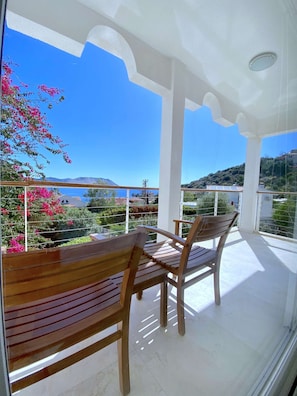 Enjoy breathtaking views of the surrounding landscape from this balcony.