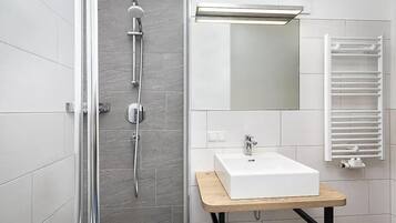 Shower, hair dryer, towels, toilet paper