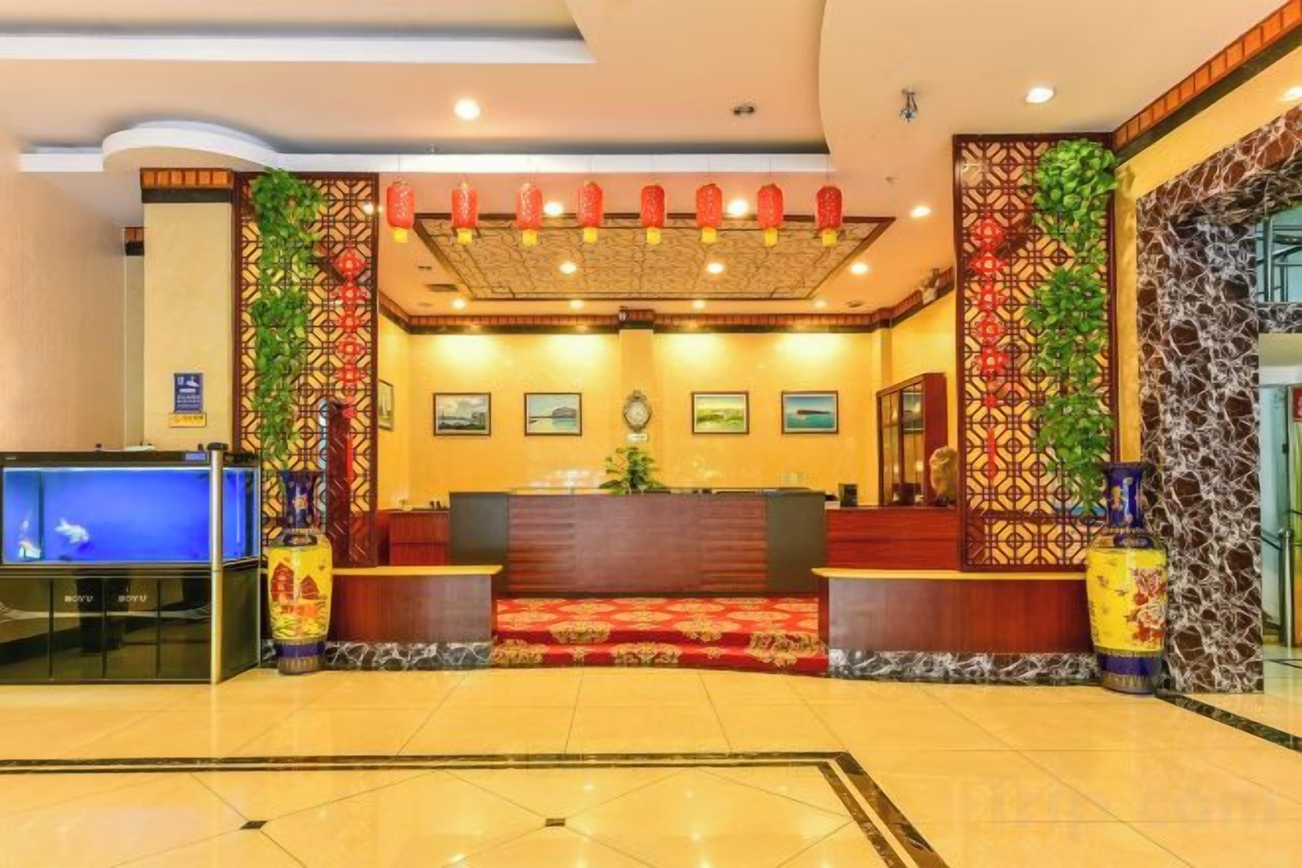 A reception area with a reception desk, a television, and decorative elements.