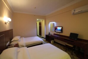 A hotel room with two beds, a desk with a computer, a TV, and a wall-mounted air conditioner. - Fuli Zonghe Service Center (Beihai)