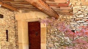 A stone building with a wooden door and a small window.