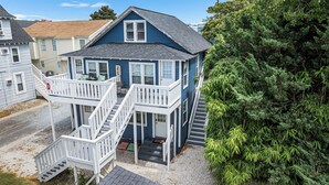 A two-story house with a balcony and a front porch. - Cozy 1 bedroom condo, Downtown, with a pool, close to the beach and the famous OC boardwalk (Ocean City)