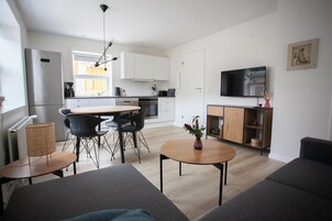 Apartment | Living area | 30-inch flat-screen TV with satellite channels