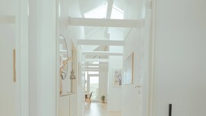 A bright hallway with a wooden floor, white walls, and a skylight. - Stunning Views / Penthouse / Decorative / Parking (Nykobing Sjaelland)