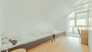 A modern bedroom with a single bed, a desk, and a chair. - Stunning Views / Penthouse / Decorative / Parking (Nykobing Sjaelland)
