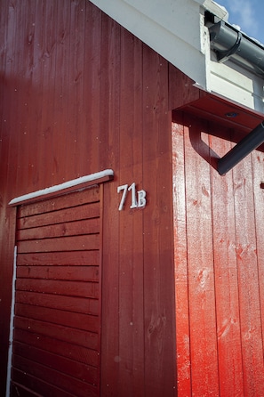A red wooden building with a garage door and the number 71B. - Tórshavn - Central - City & Ocean Views - 3Br (Tórshavn)